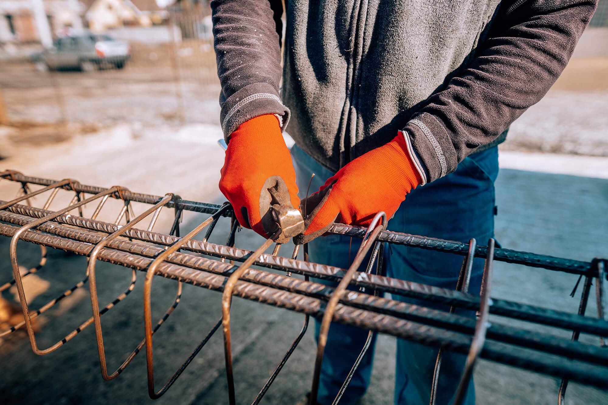 Construction worker installing rebar reinforcement — Sharp Edge Construction